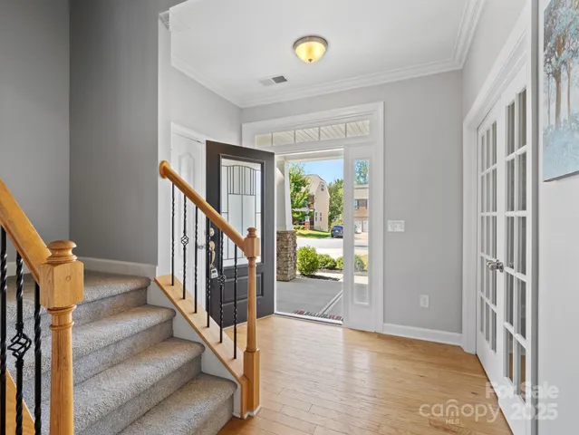 a view of an entryway with wooden floor