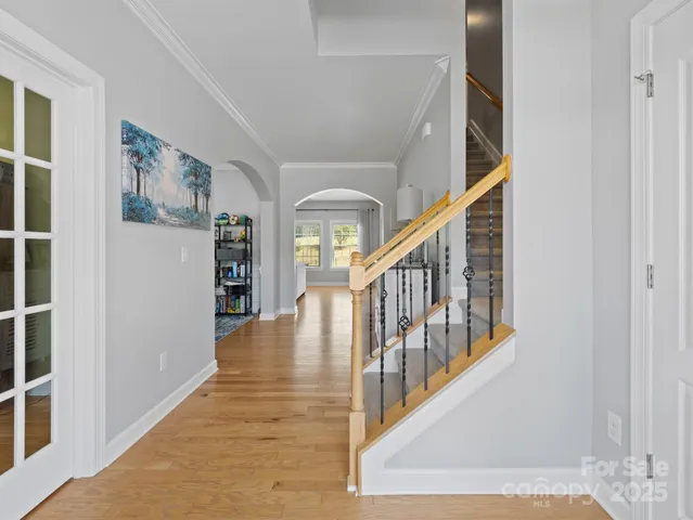 a view of an entryway with wooden floor and a front door