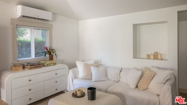 a bedroom with furniture and a window