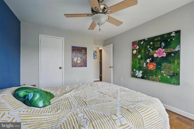 a bed room with a bed and a painting on the wall