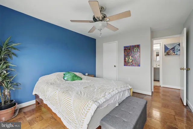 a bedroom with a bed and a potted plant