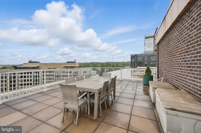 a view of a terrace with furniture and city view