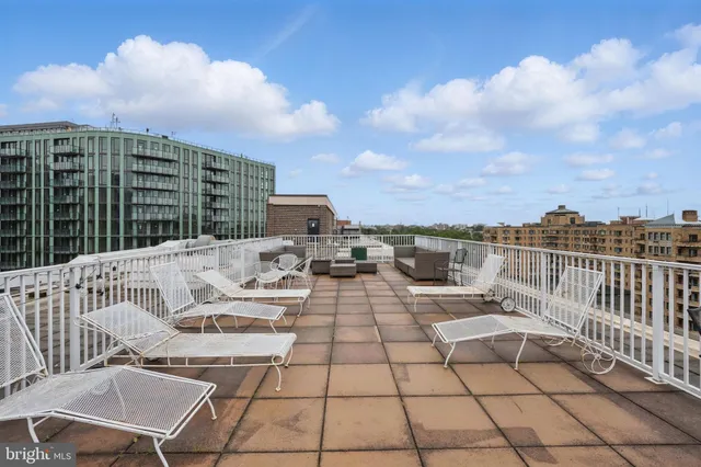 a view of a patio with a table and chairs and potted plants