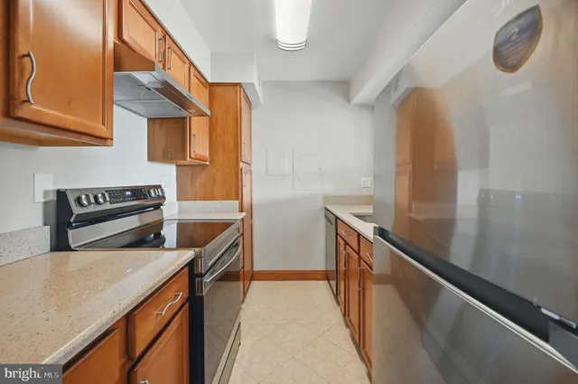 a kitchen with stainless steel appliances granite countertop a sink and a stove