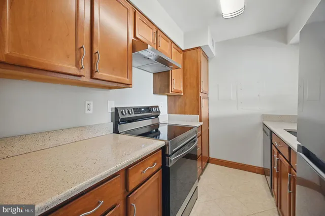 a kitchen with stainless steel appliances granite countertop a stove and a microwave
