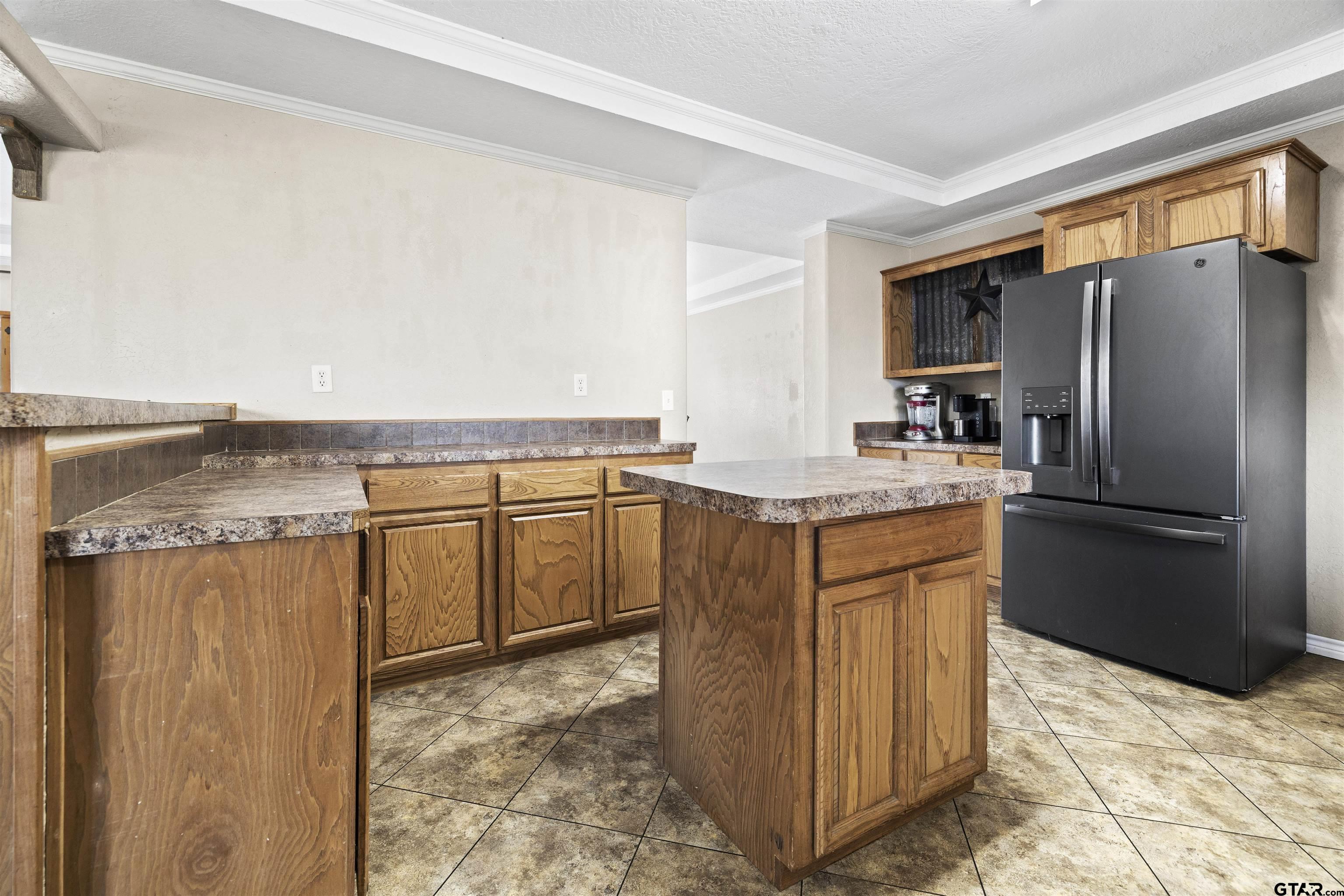 2089 Cottonwood Road Gilmer, TX 75645 - Photo 12 of 30 a kitchen with stainless steel appliances granite countertop a refrigerator a stove and a sink