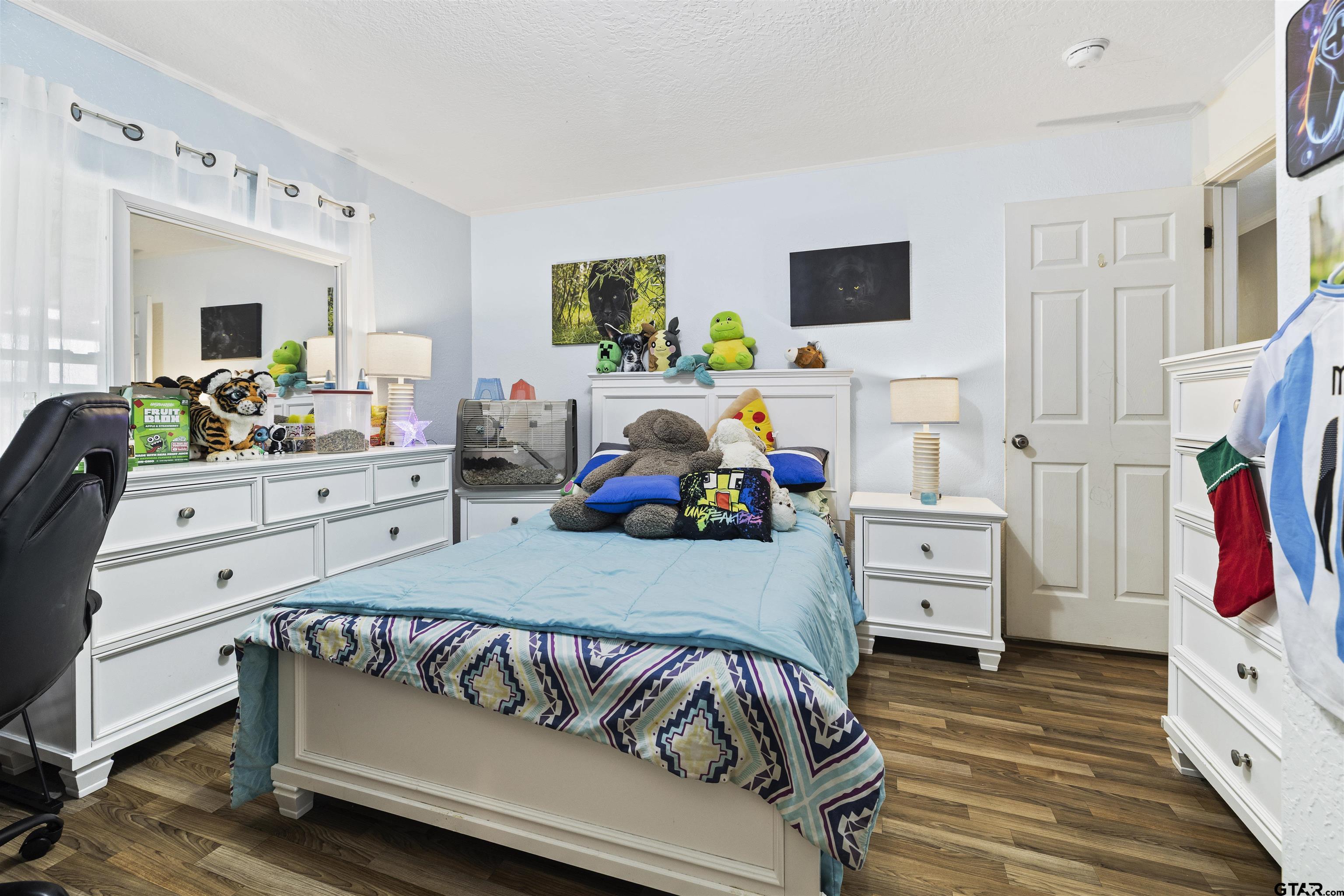 2089 Cottonwood Road Gilmer, TX 75645 - Photo 18 of 30 a bedroom with furniture and a flat screen tv