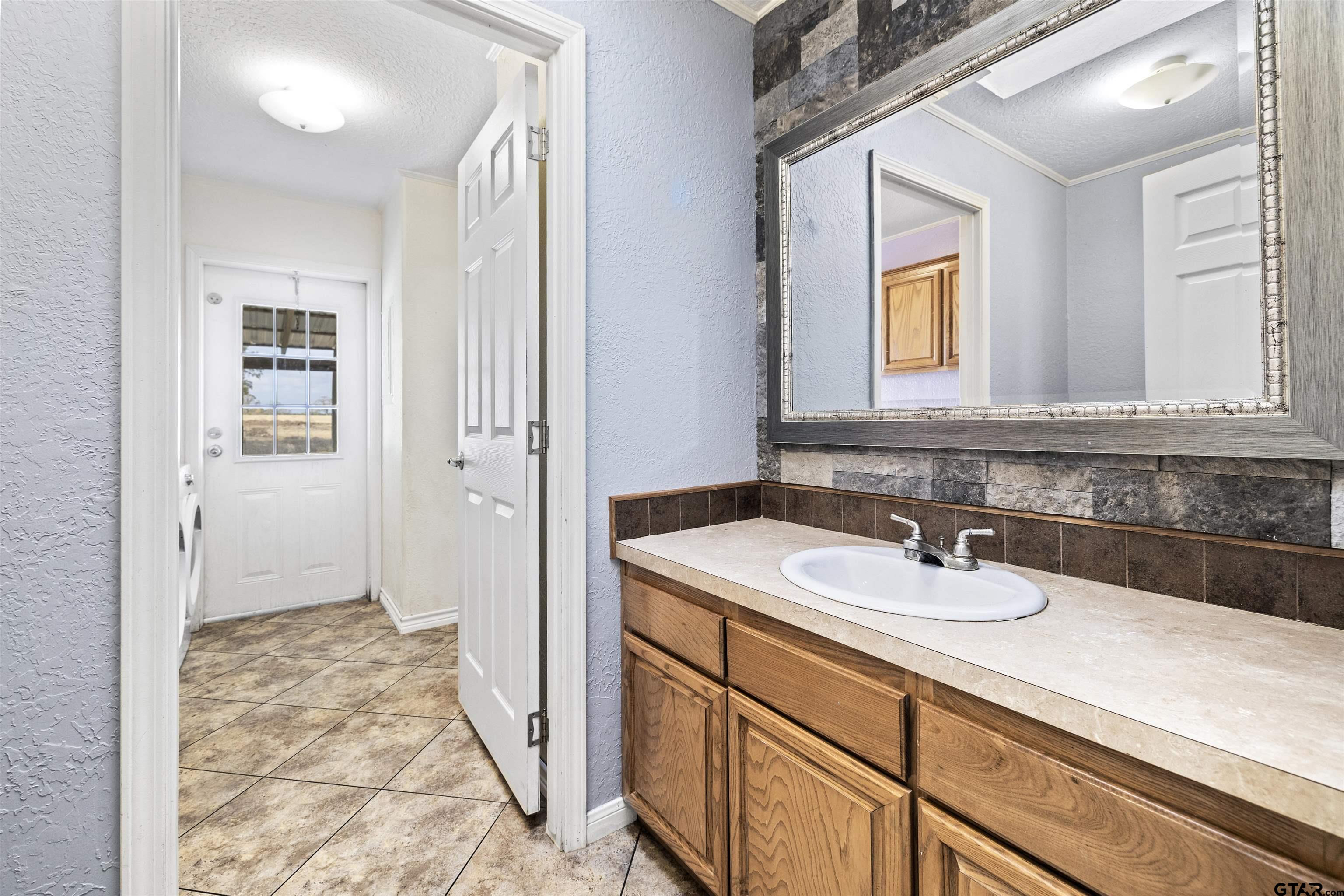 2089 Cottonwood Road Gilmer, TX 75645 - Photo 19 of 30 a bathroom with a sink and a mirror