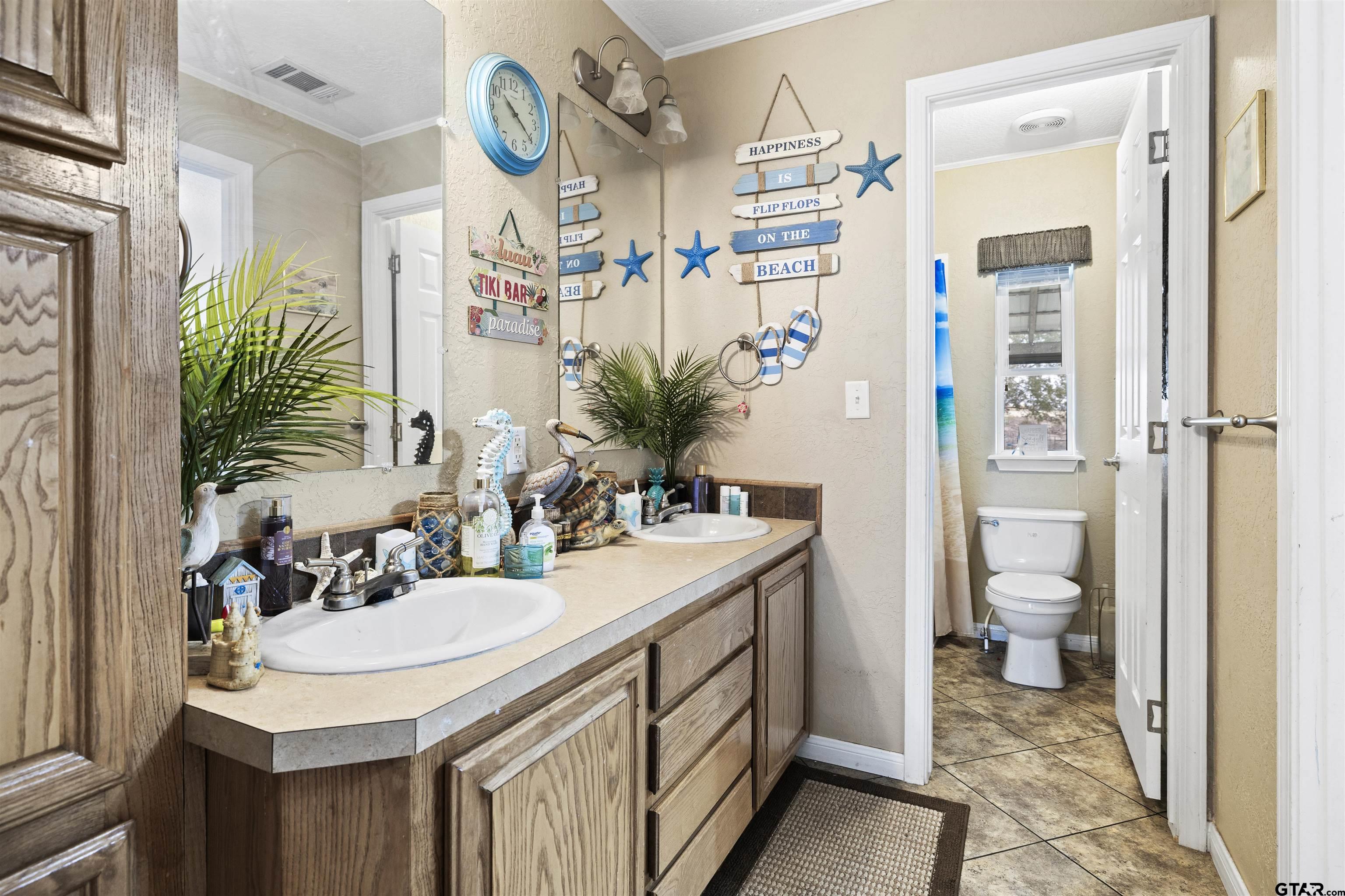 2089 Cottonwood Road Gilmer, TX 75645 - Photo 21 of 30 a bathroom with a sink a toilet and shower