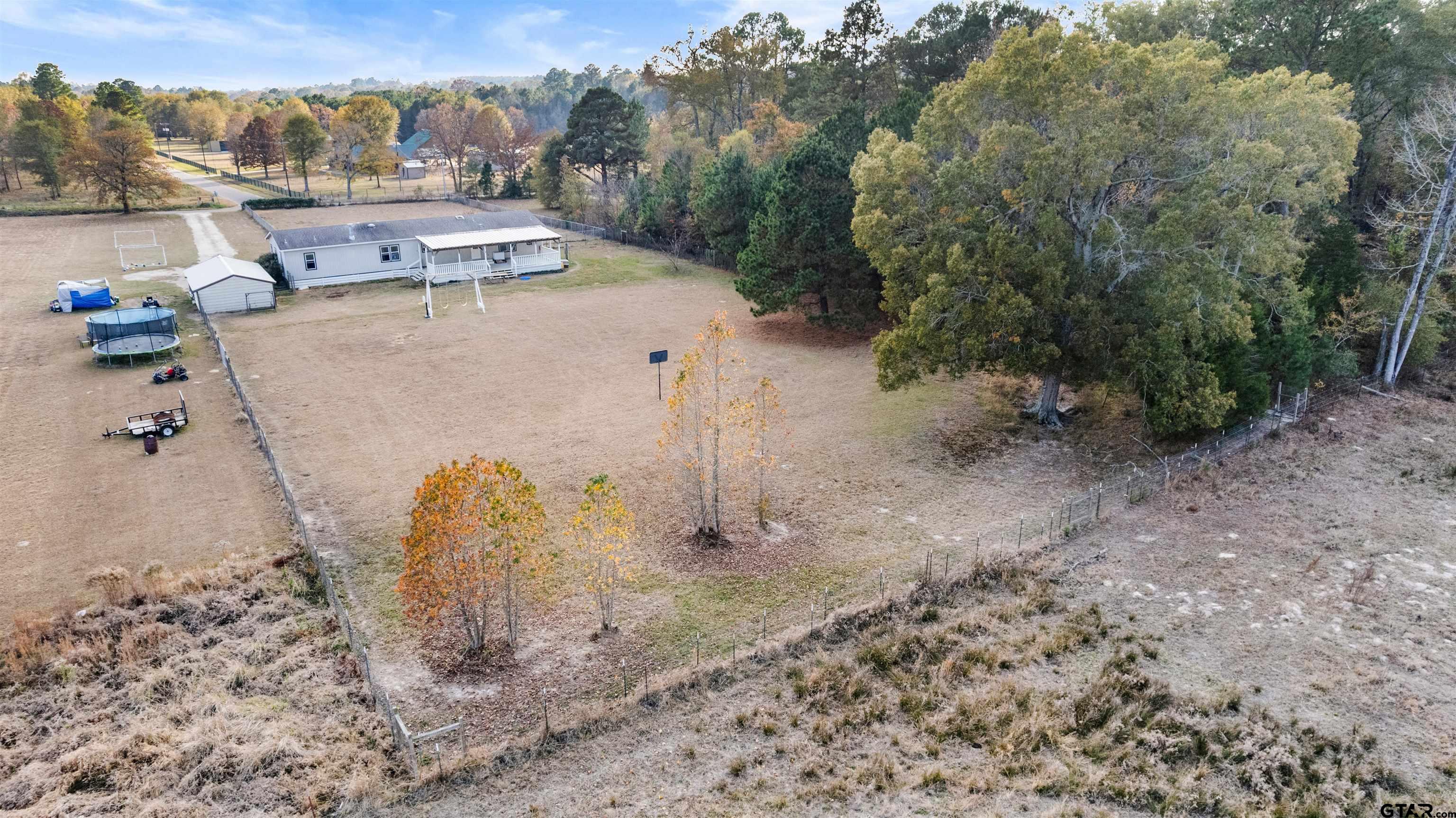 2089 Cottonwood Road Gilmer, TX 75645 - Photo 29 of 30 a view of a dry yard with trees