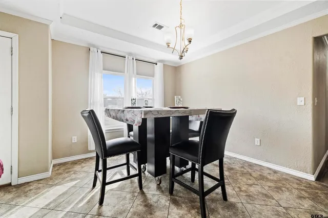 a kitchen with stainless steel appliances granite countertop a kitchen island a stove a sink a refrigerator and a microwave