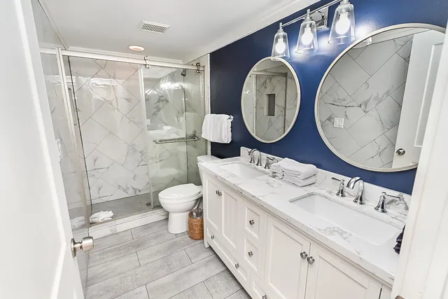 a bathroom with a toilet a sink and a mirror