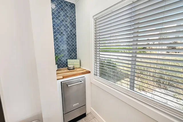a view of a kitchen that has a stove and a window