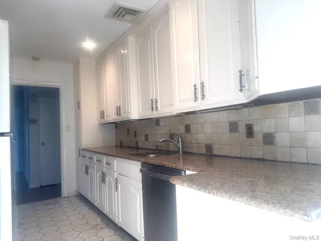 a kitchen with stainless steel appliances granite countertop a sink and a granite counter tops