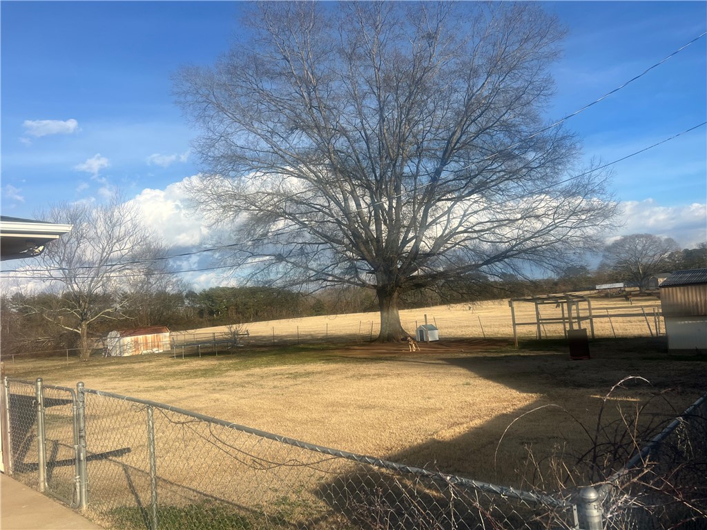 106 Donhill Road Anderson, SC 29625 - Photo 11 of 11 Expansive outdoor area with mature trees and vast open fields.