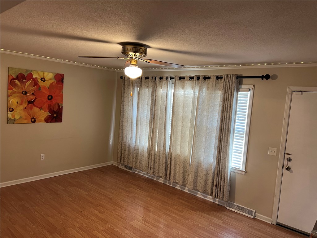 106 Donhill Road Anderson, SC 29625 - Photo 2 of 11 This inviting living area features warm wood flooring and abundant natural light.