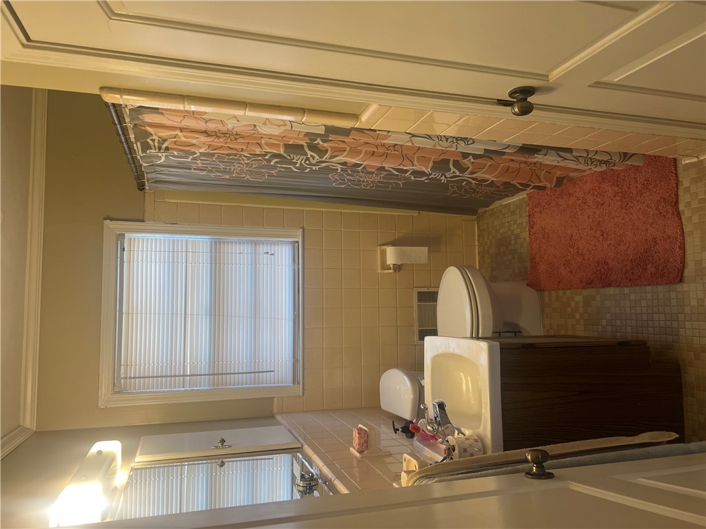 106 Donhill Road Anderson, SC 29625 - Photo 6 of 11 This bathroom features a shower and tiled walls, creating a clean and functional space.