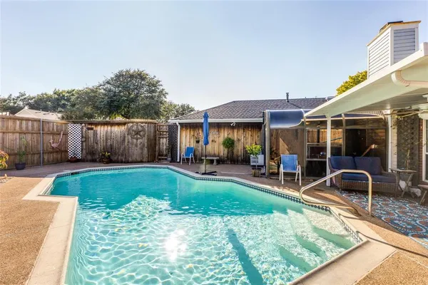 a view of a house with backyard and sitting area