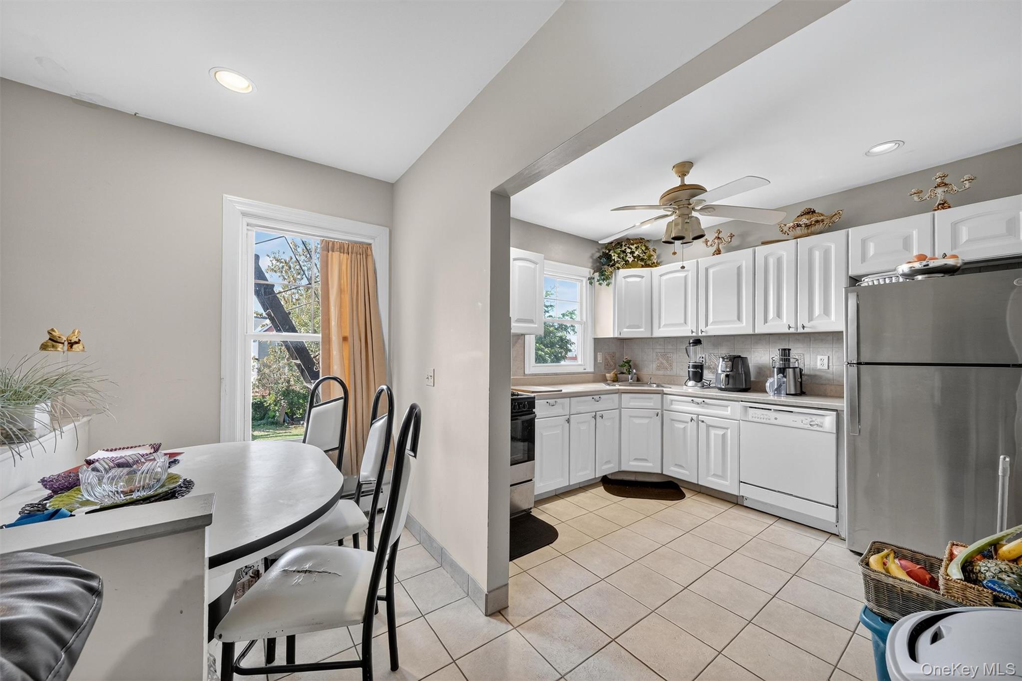 16 Maple Place Ossining, NY 10562 - Photo 20 of 45 a kitchen with a refrigerator and a dining table