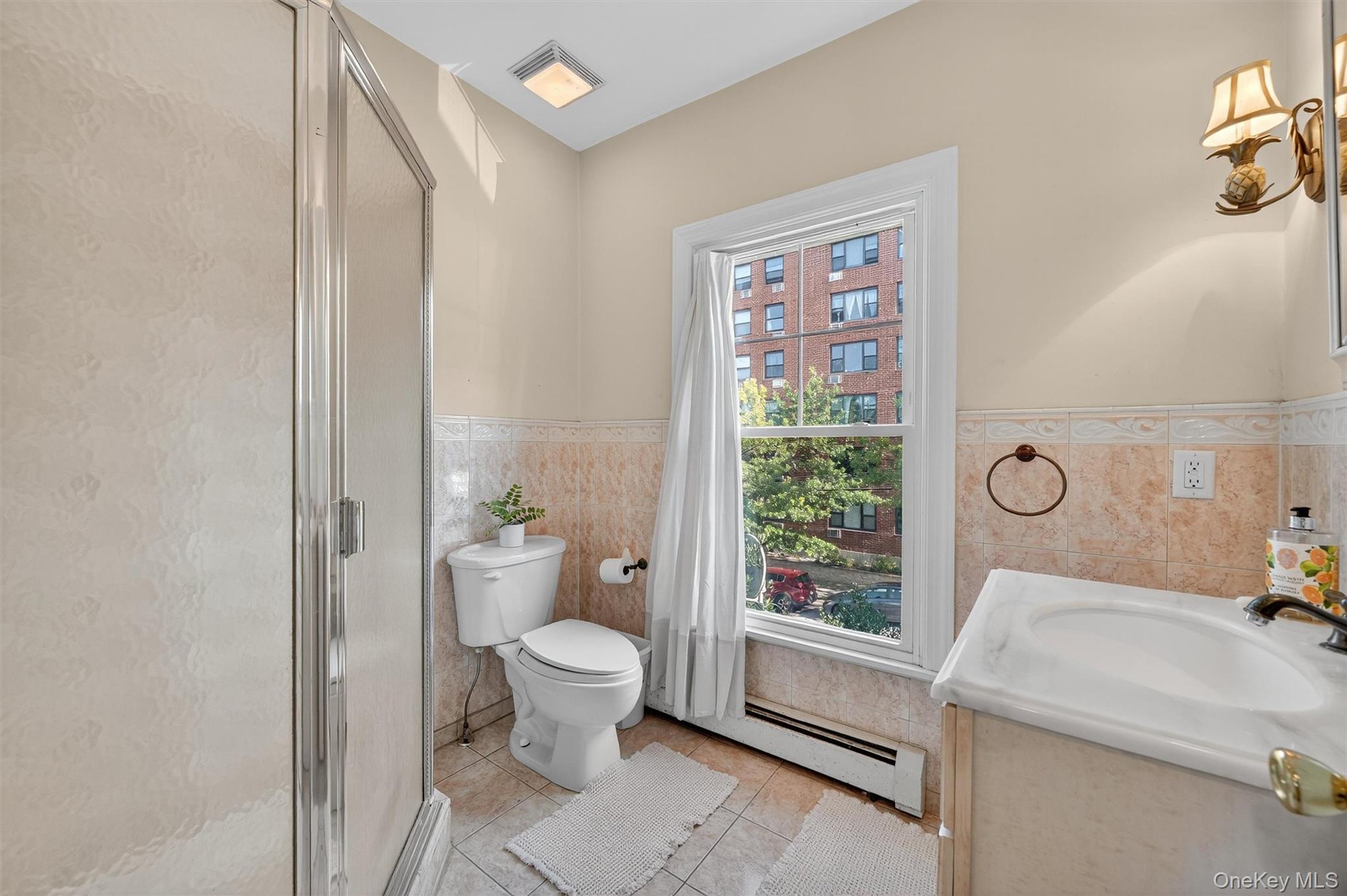 16 Maple Place Ossining, NY 10562 - Photo 26 of 45 a bathroom with a granite countertop toilet a sink and a mirror