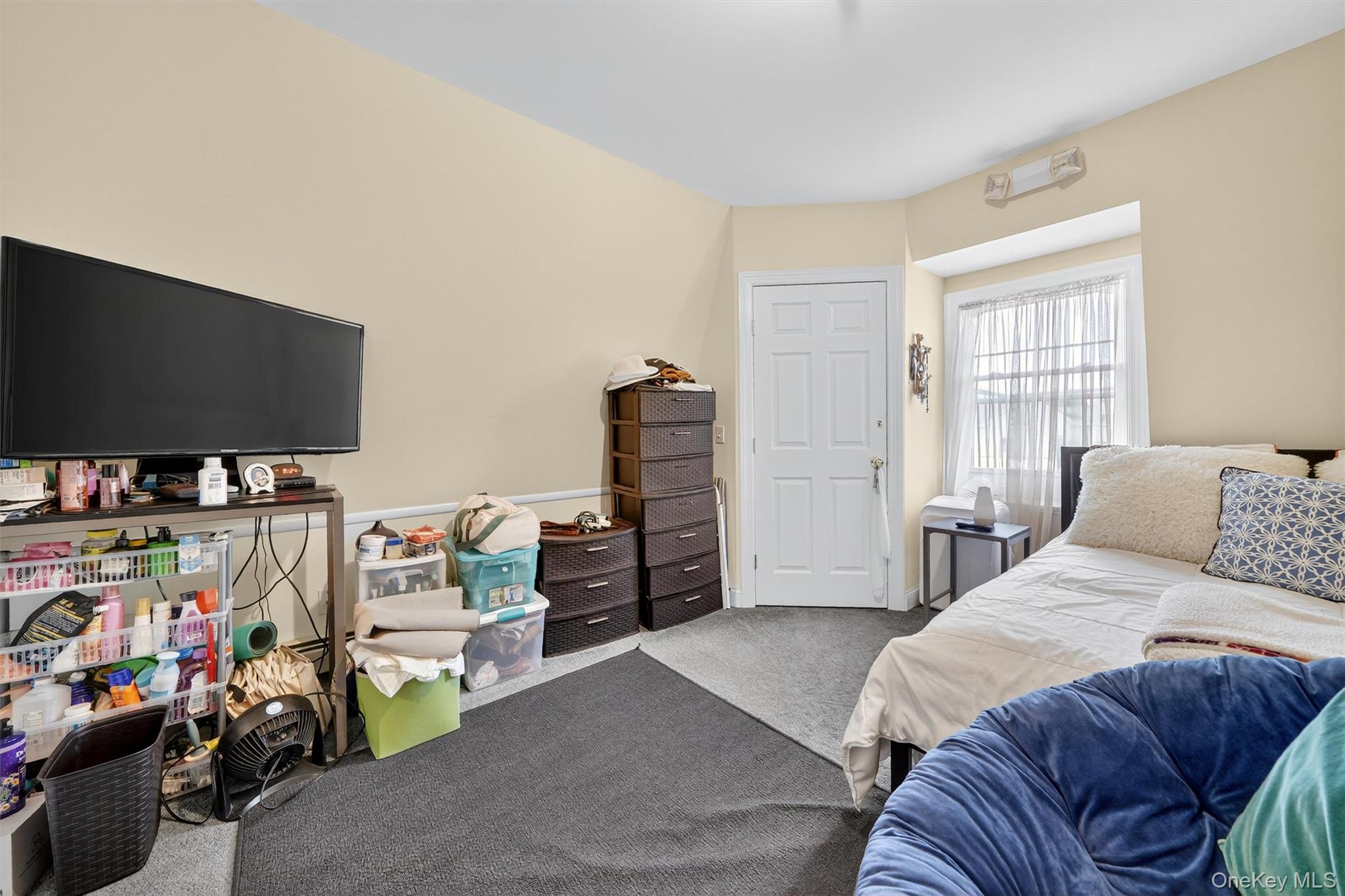 16 Maple Place Ossining, NY 10562 - Photo 28 of 45 a bedroom with a bed and a flat screen tv