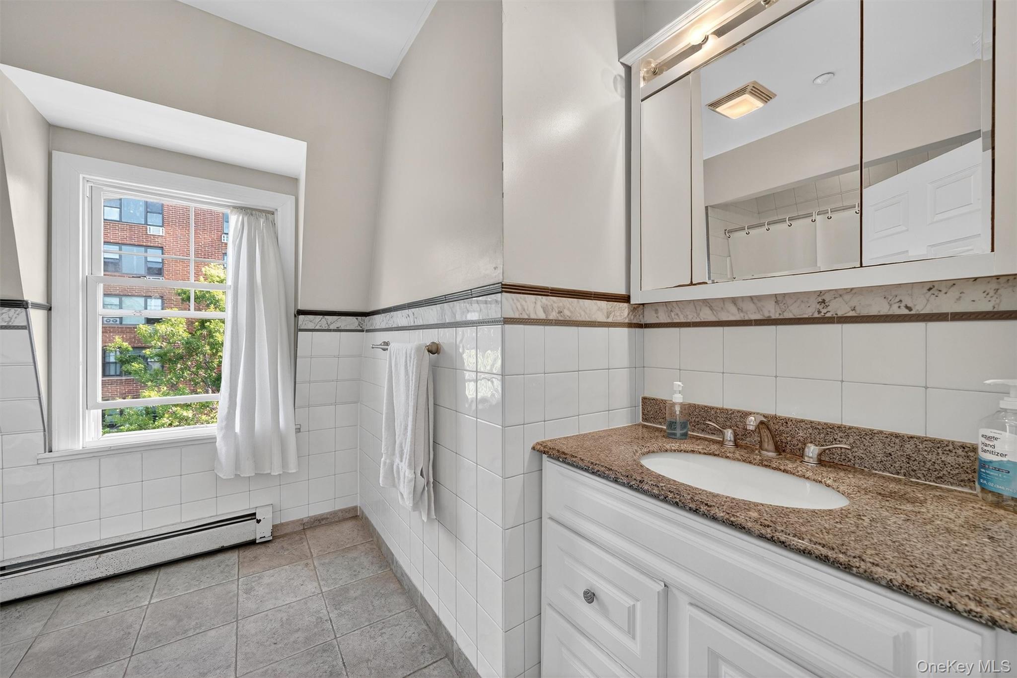 16 Maple Place Ossining, NY 10562 - Photo 34 of 45 a bathroom with a granite countertop sink and a mirror
