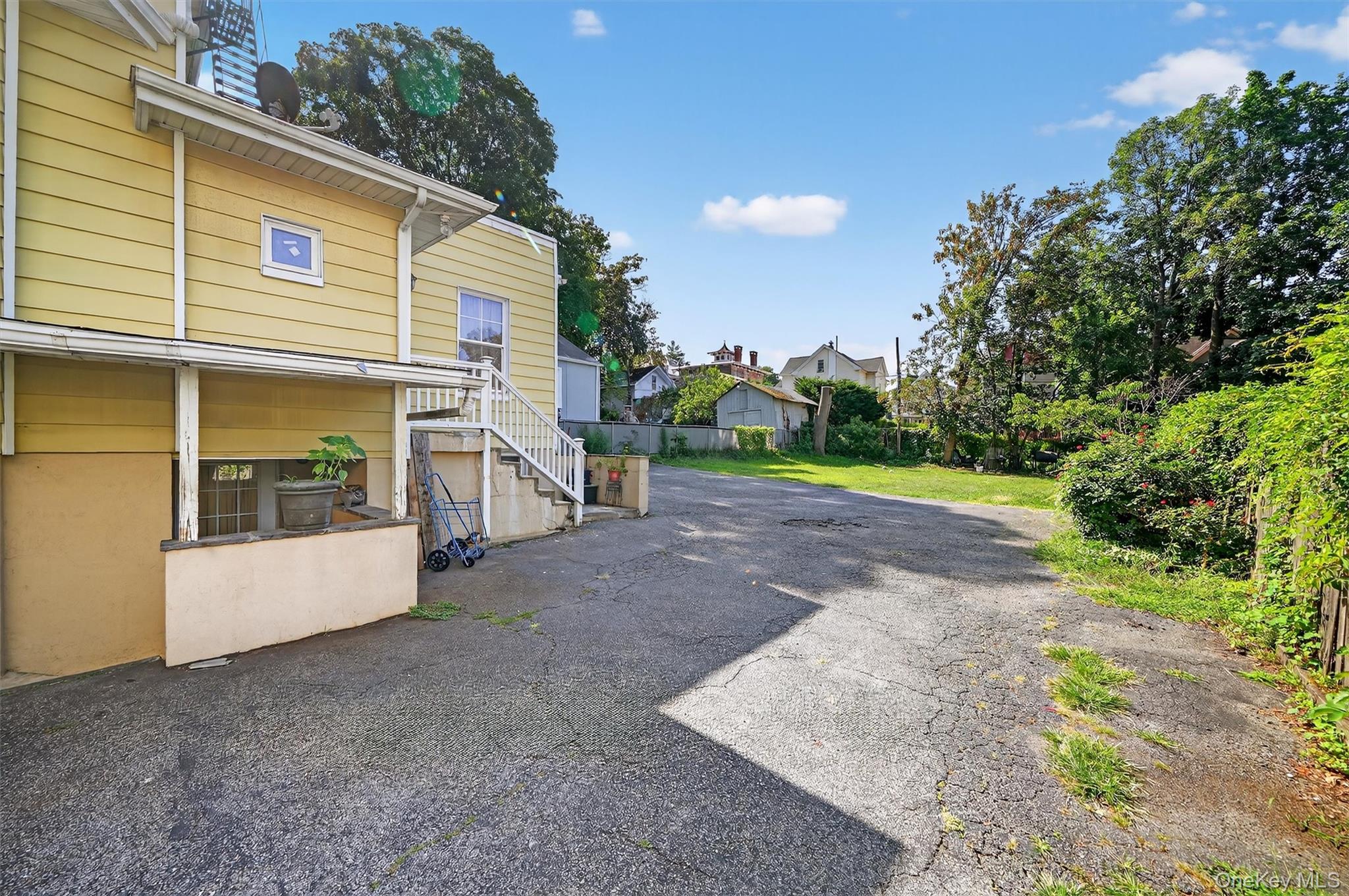 16 Maple Place Ossining, NY 10562 - Photo 39 of 45 a view of a house with a yard and garage