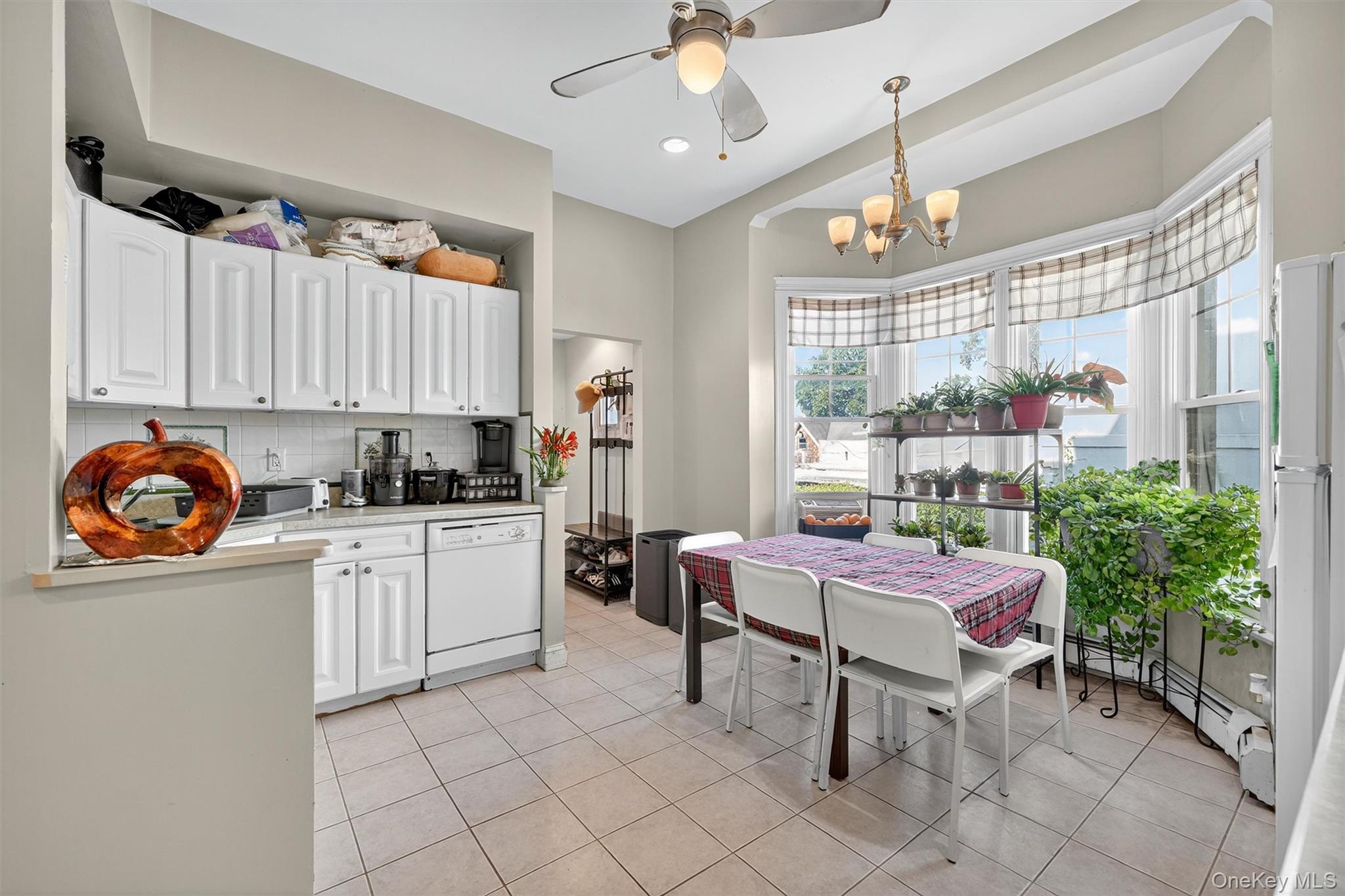 16 Maple Place Ossining, NY 10562 - Photo 10 of 45 a kitchen with stainless steel appliances a table and chairs in it