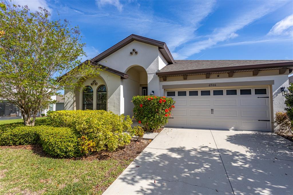 6906 Paradiso Drive Apollo Beach, FL 33572 - Photo 1 of 37 a front view of a house with a yard