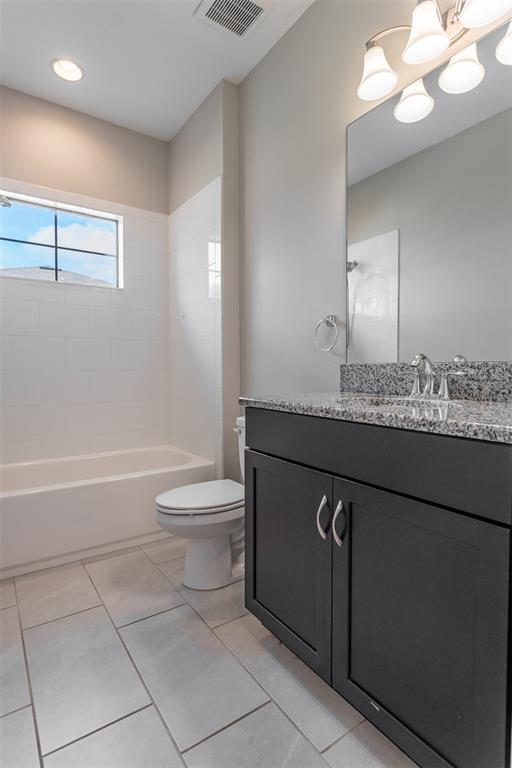 6906 Paradiso Drive Apollo Beach, FL 33572 - Photo 14 of 37 a bathroom with a granite countertop sink a toilet and mirror
