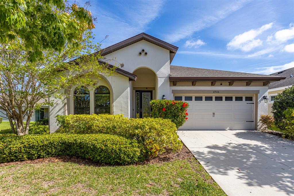 6906 Paradiso Drive Apollo Beach, FL 33572 - Photo 2 of 37 a front view of a house with a garden