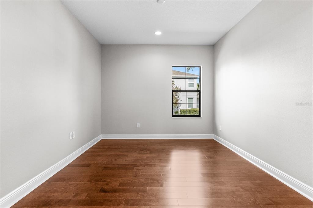 6906 Paradiso Drive Apollo Beach, FL 33572 - Photo 23 of 37 an empty room with wooden floor and windows