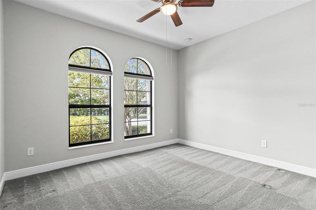 6906 Paradiso Drive Apollo Beach, FL 33572 - Photo 24 of 37 an empty room with windows and ceiling fan
