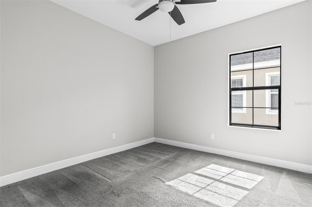 6906 Paradiso Drive Apollo Beach, FL 33572 - Photo 25 of 37 an empty room with windows and fan