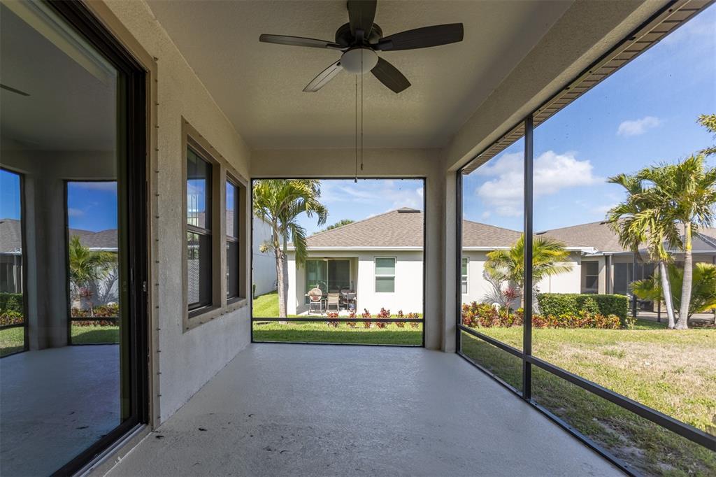 6906 Paradiso Drive Apollo Beach, FL 33572 - Photo 29 of 37 a view of a porch with a floor to ceiling window next to a living room