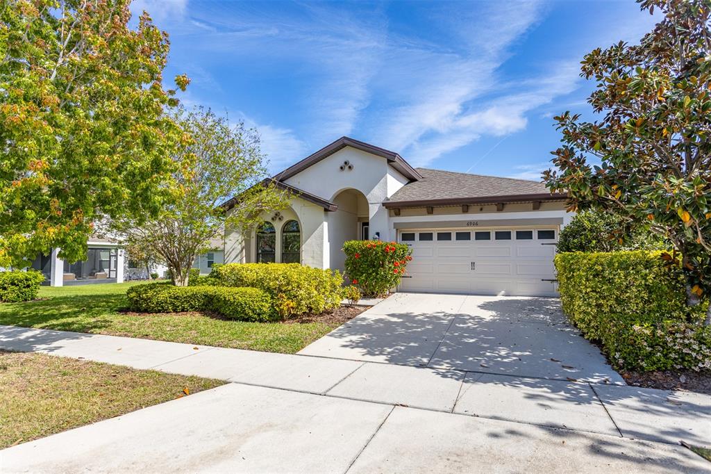 6906 Paradiso Drive Apollo Beach, FL 33572 - Photo 36 of 37 a front view of a house with a yard and garage