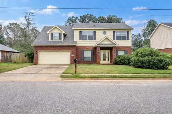 a front view of a house with a yard and garage