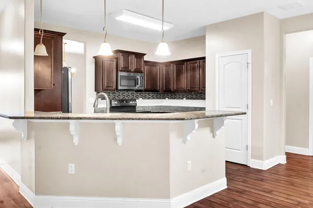 a bathroom with a sink toilet vanity and shower