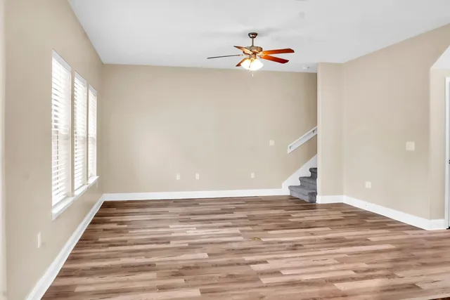 a view of a room with wooden floor and chandelier