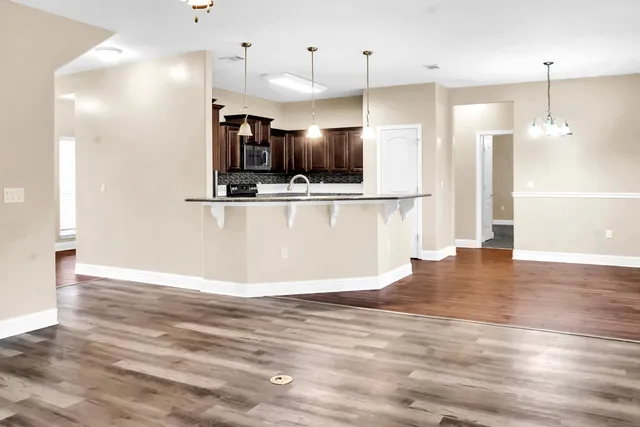 a kitchen with stainless steel appliances granite countertop a refrigerator and a sink