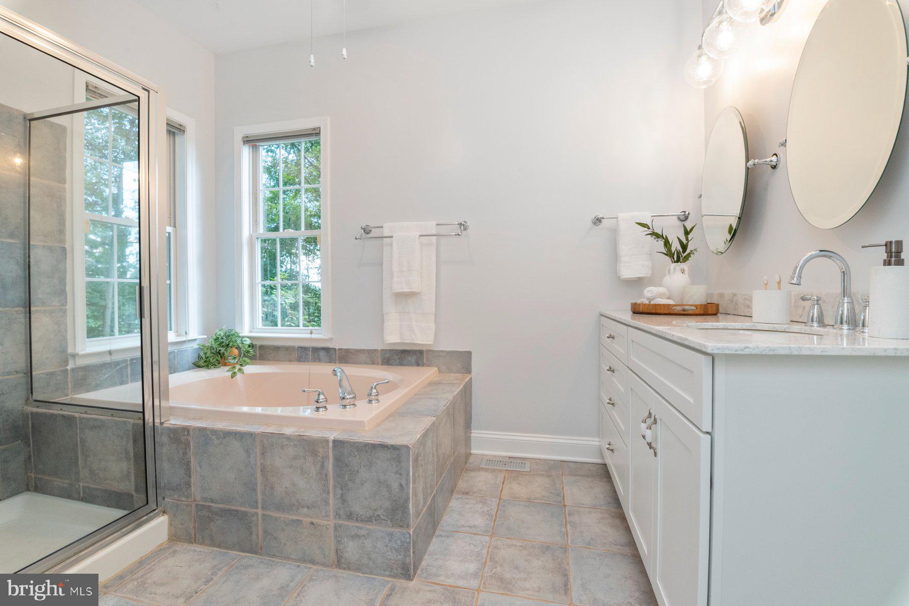 1012 Bernoudy Road White Hall, MD 21161 - Photo 15 of 28 a spacious bathroom with a tub sink and mirror