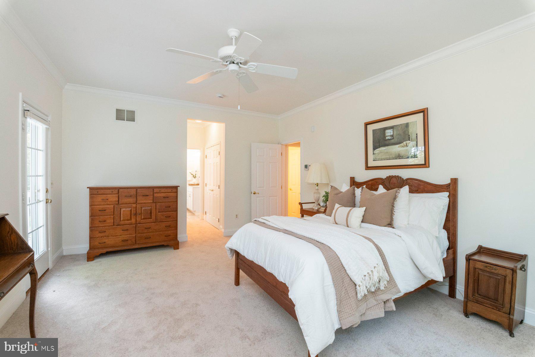 1012 Bernoudy Road White Hall, MD 21161 - Photo 18 of 28 a spacious bedroom with a bed a dresser and potted plant