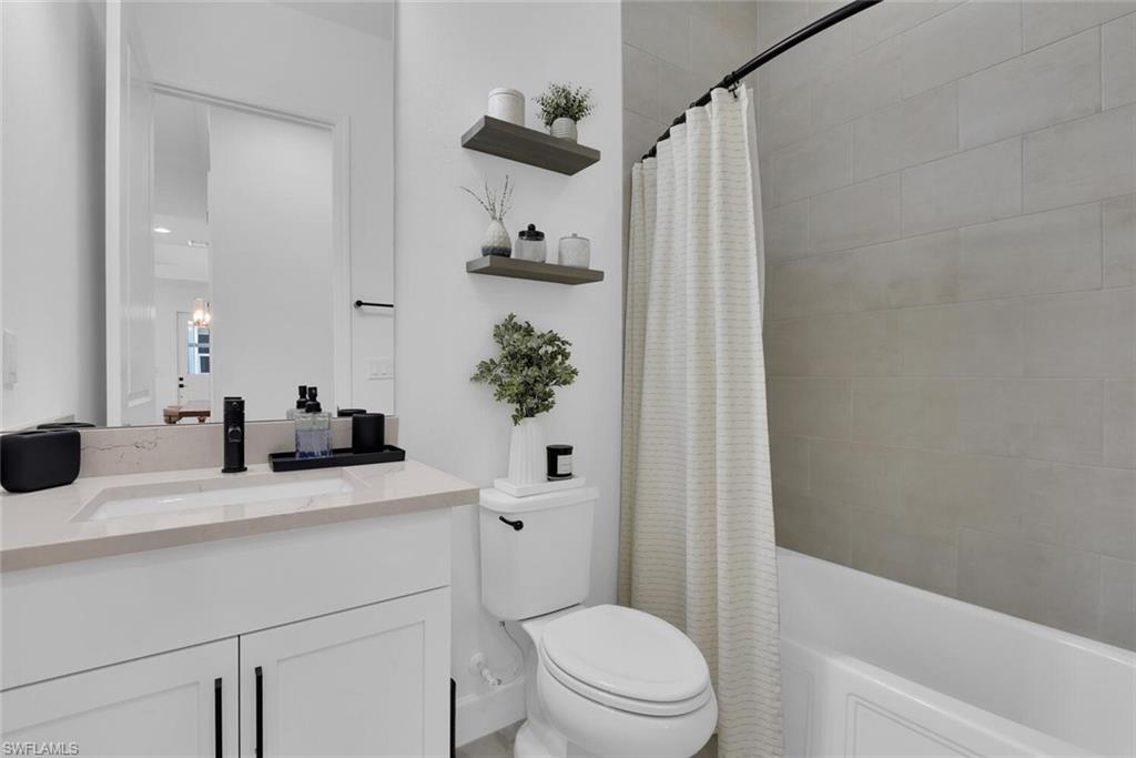 7242 Saona Court Naples, FL 34113 - Photo 11 of 34 a bathroom with a sink a toilet and shower