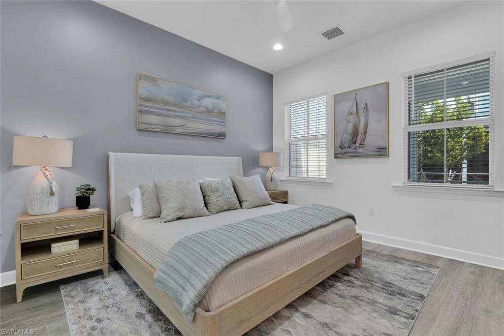 7242 Saona Court Naples, FL 34113 - Photo 12 of 34 a bedroom with a large bed and a window