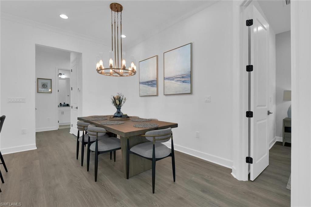 7242 Saona Court Naples, FL 34113 - Photo 6 of 34 a view of a dining room with furniture wooden floor and chandelier