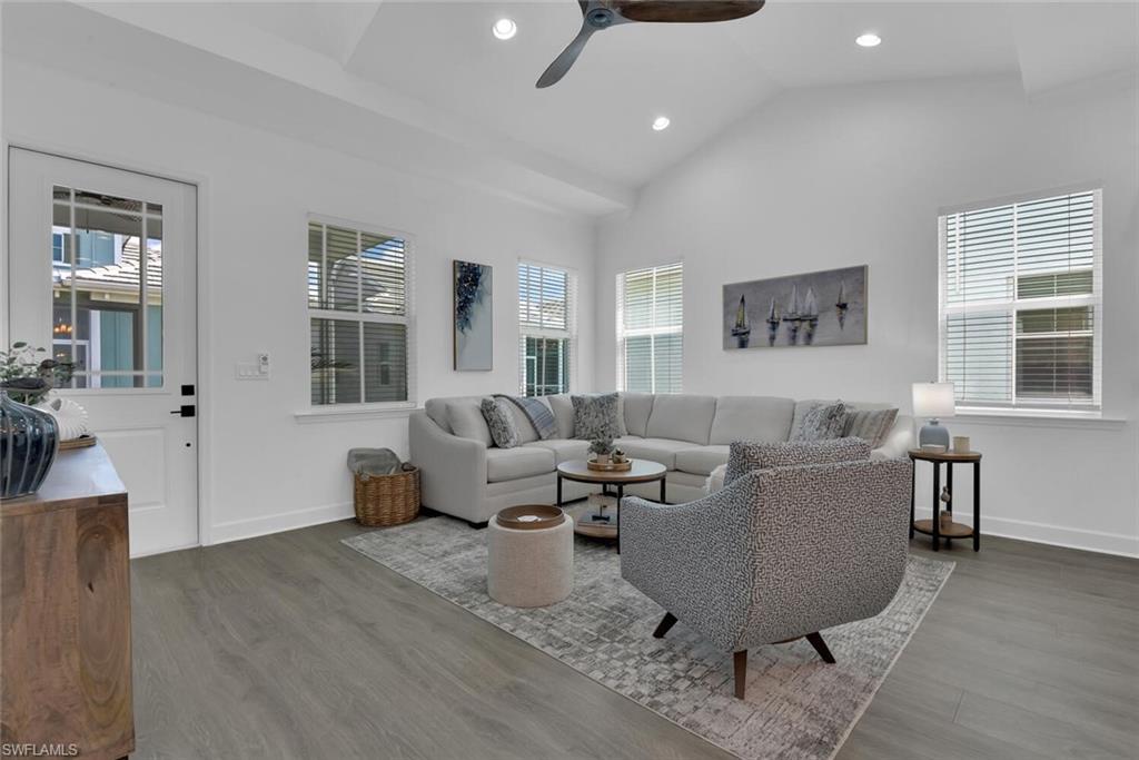 7242 Saona Court Naples, FL 34113 - Photo 8 of 34 a living room with furniture and wooden floor