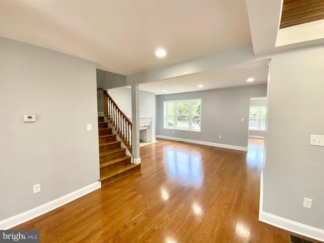 a view of entryway with wooden floor and stairs
