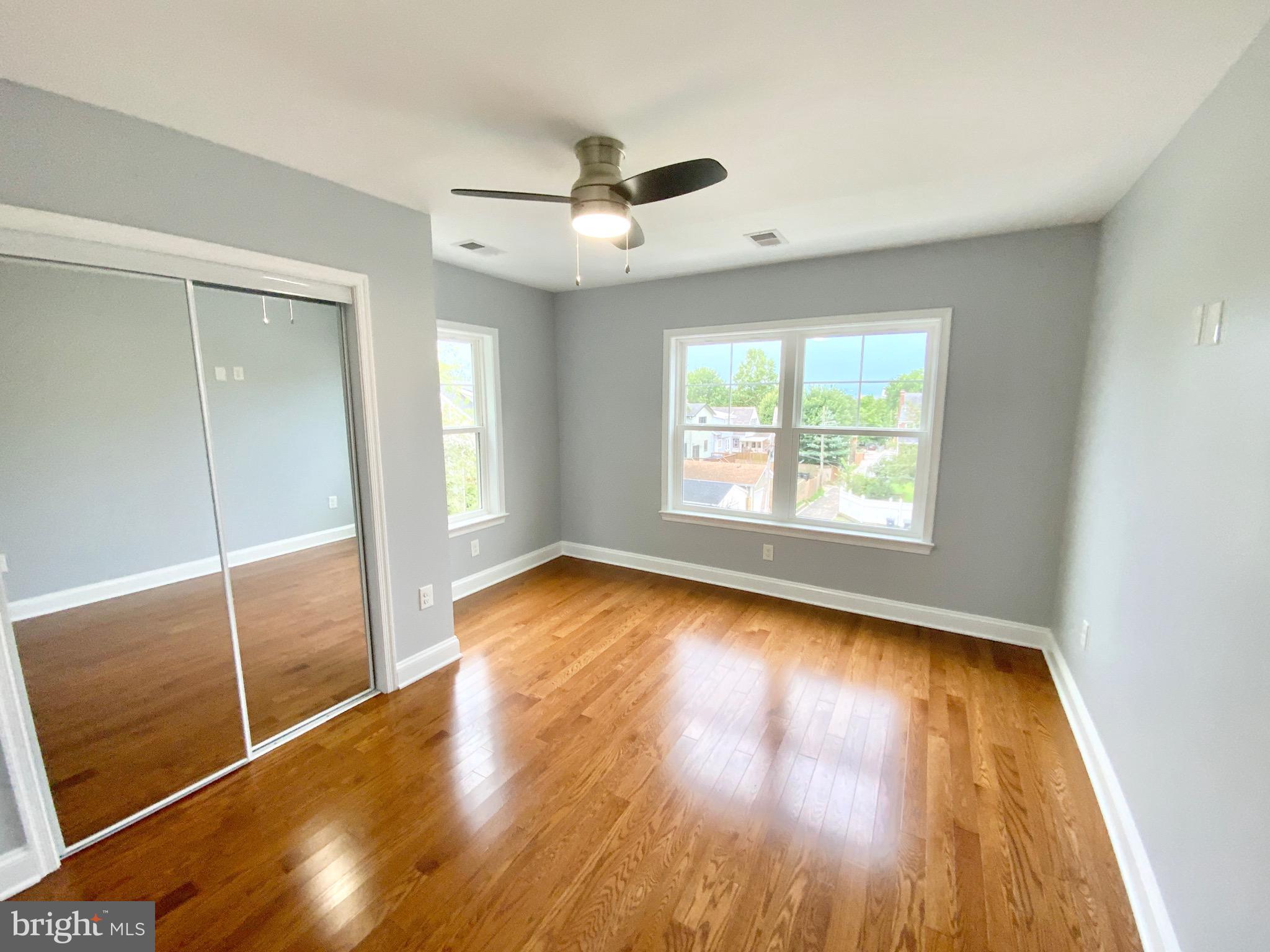 1318 Ingraham Street Northwest Washington, DC 20011 - Photo 15 of 35 wooden floor in an empty room with a window