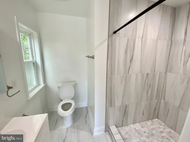a bathroom with a toilet and shower
