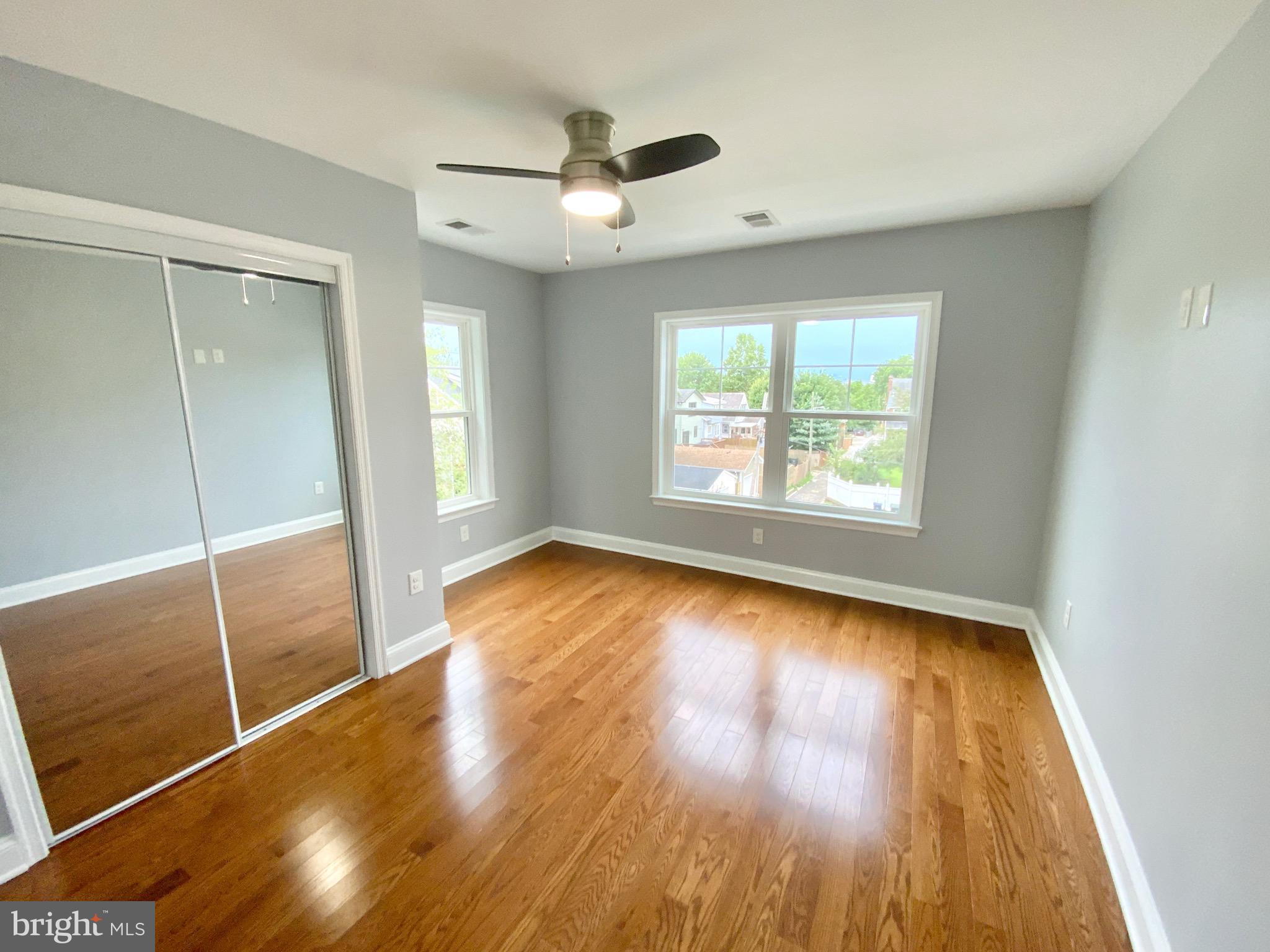 1318 Ingraham Street Northwest Washington, DC 20011 - Photo 19 of 35 an empty room with wooden floor and windows